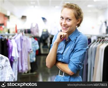 Young woman in a shop buying clothes