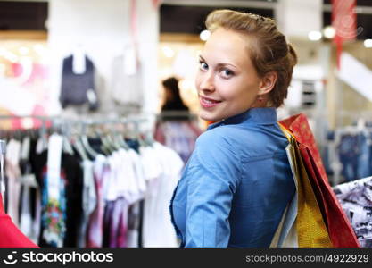 Young woman in a shop buying clothes