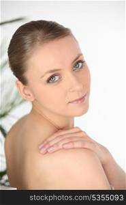 Young woman in a towel looking over her shoulder
