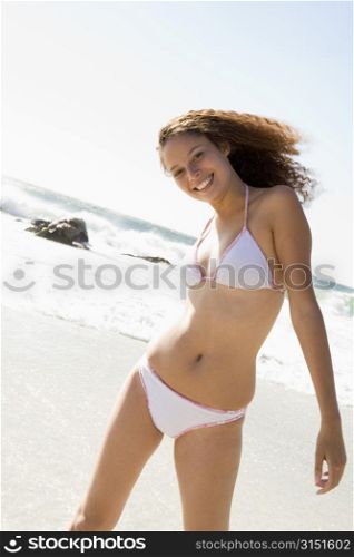 Young woman in a two piece bathing suit on a beach
