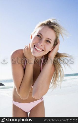 Young woman in a two piece bathing suit on a beach