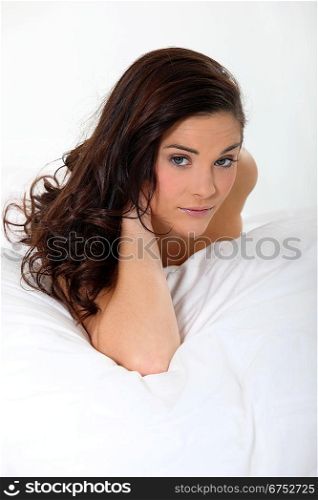 Young woman in a white bed