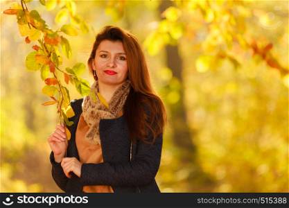 Young woman in autumnal park. Fashion nature beauty concept. . Young woman in autumnal park
