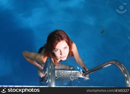 Young woman in basin stair a summer day