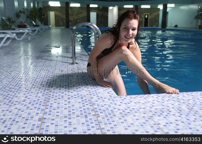 Young woman in basin stair a summer day