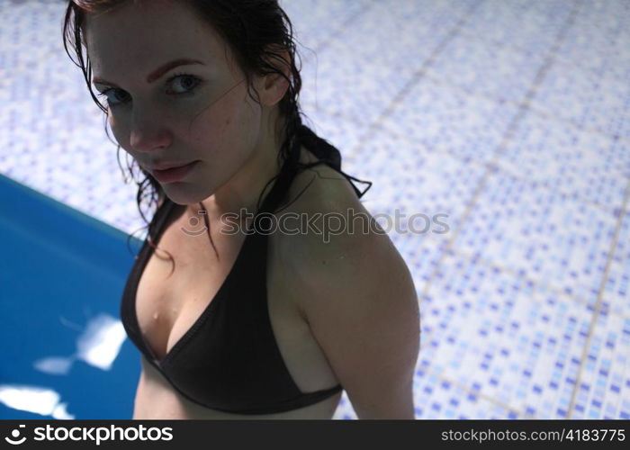 Young woman in basin stair a summer day