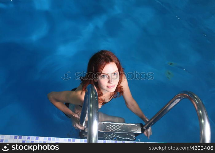 Young woman in basin stair a summer day