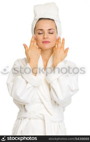 Young woman in bathrobe after facial treatment