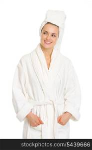 Young woman in bathrobe looking on copy space
