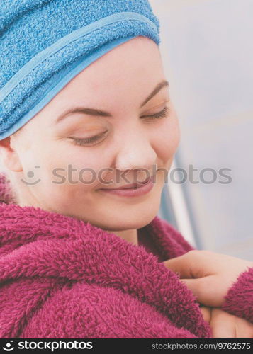 Young woman in bathroom after taking shower feeling clean and relaxed wearing towel and bathrobe. Woman in towel after shower