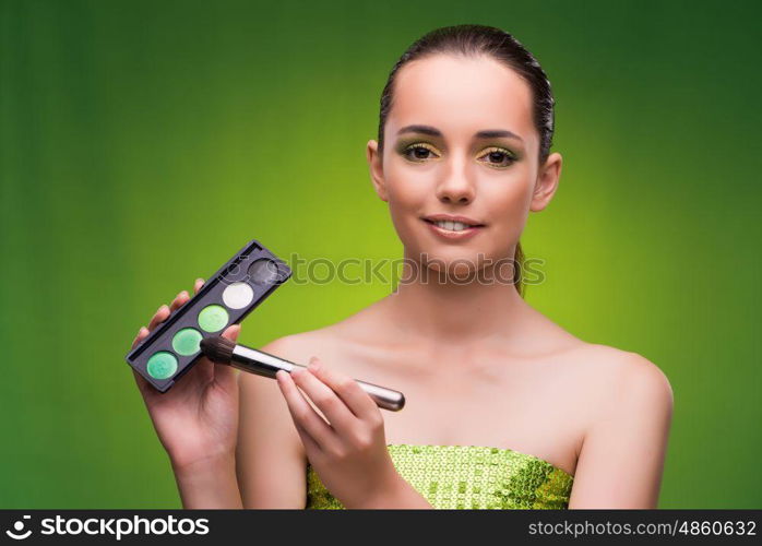 Young woman in beauty concept on green background