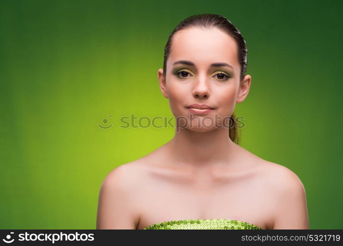 Young woman in beauty concept on green background