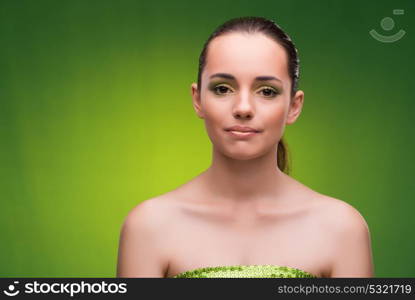 Young woman in beauty concept on green background