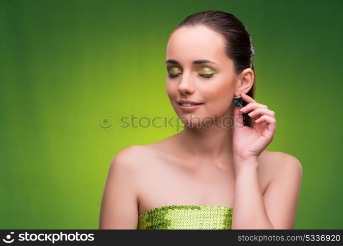 Young woman in beauty concept on green background