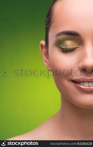 Young woman in beauty concept on green background