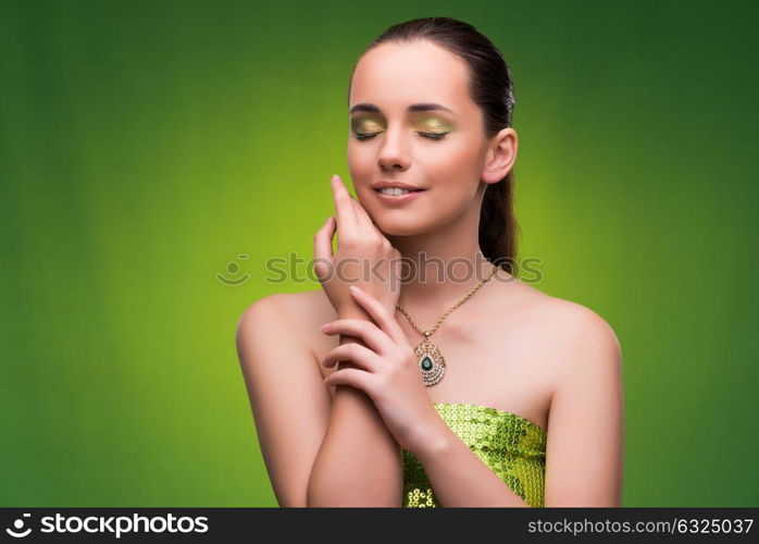 Young woman in beauty concept on green background