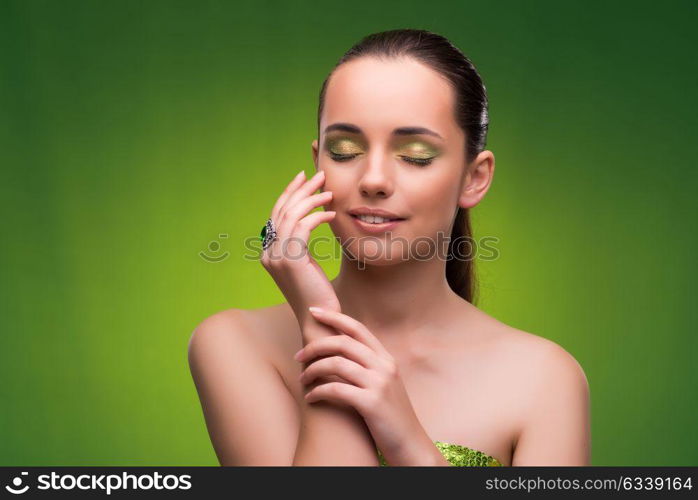 Young woman in beauty concept on green background