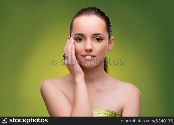 Young woman in beauty concept on green background