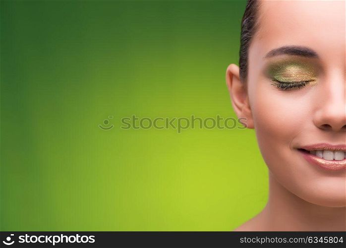 Young woman in beauty concept on green background