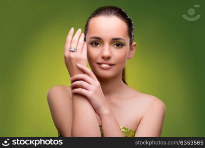 Young woman in beauty concept on green background