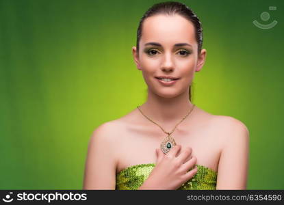 Young woman in beauty concept on green background