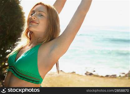 Young woman in bikini at beach half length