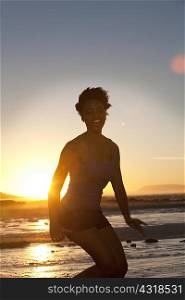Young woman in bikini by seaside