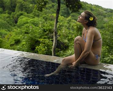 Young Woman in Bikini by Swimming Pool