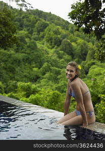Young Woman in Bikini by Swimming Pool