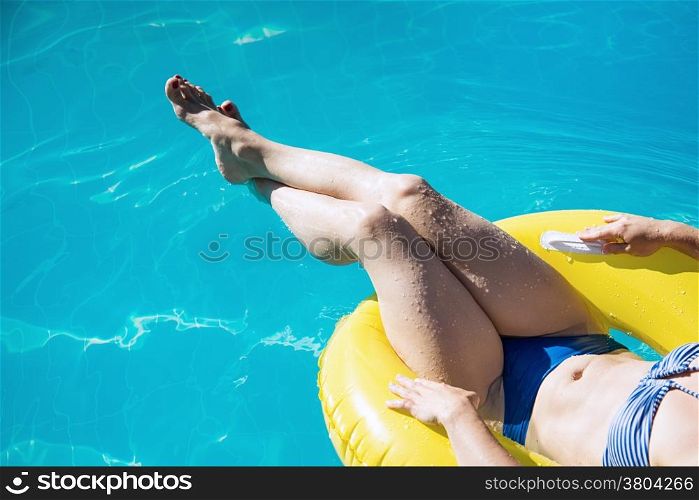 Young woman in bikini enjoying a swimming pool