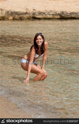 Young woman in bikini in the sea on sunny day
