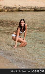 Young woman in bikini in the sea on sunny day