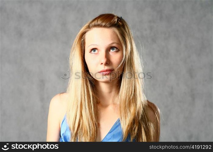 young woman in blue dress studio shot on gray