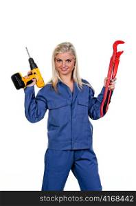 young woman in blue work clothes with a drill.