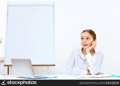 Young woman in business wear generating ideas in office