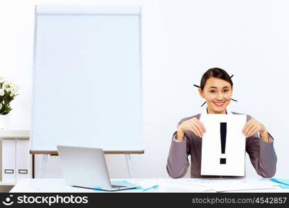 Young woman in business wear generating ideas in office