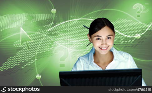 Young woman in business wear in headset working with computer