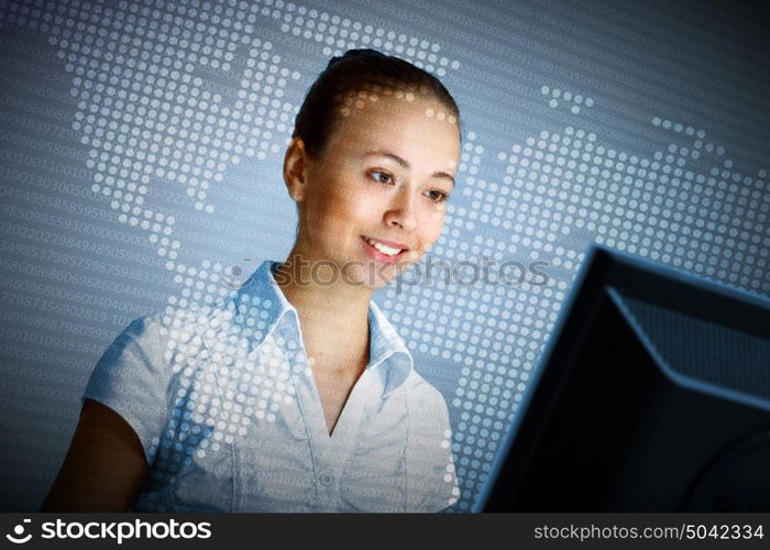 Young woman in business wear in headset working with computer