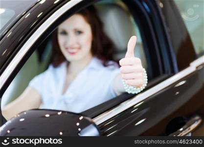 Young woman in car. Attractive young woman sitting in car in car center