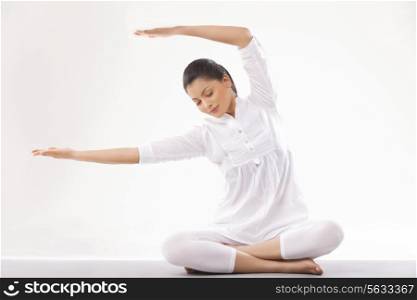 Young woman in casual clothes practicing yoga