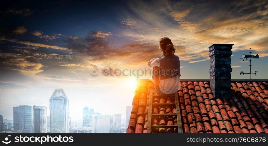 Young woman in casual clothes sitting on a house roof relaxed. Young woman in casual clothes lying relaxed with feet raised up