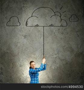 Young woman in casual holding cloud on lead. Weather concept
