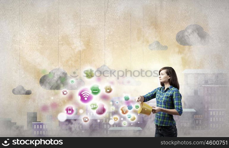 Young woman in casual holding yellow bucket with icons