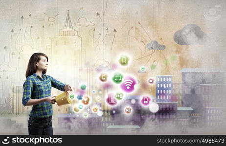 Young woman in casual holding yellow bucket with icons