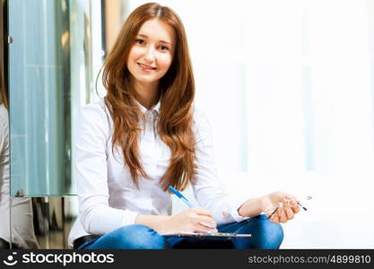 Young woman in casual. Image of young red hair woman in casual wear