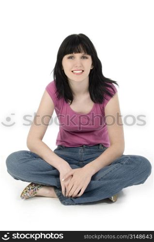 Young woman in casual outfit smiling. Sitting on white background