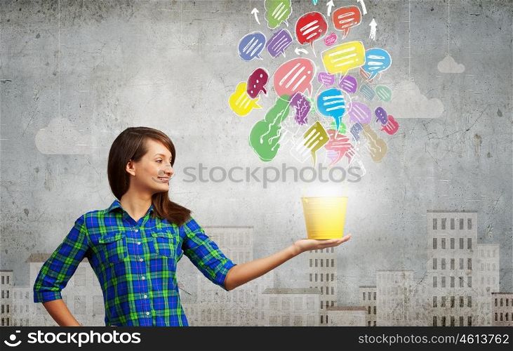 Young woman in casual with yellow bucket in hands