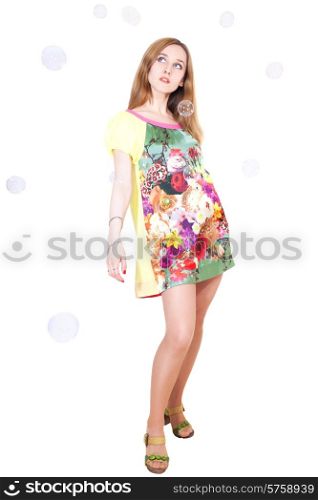young woman in color sarafan with soap bubbles on white background