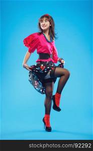 Young woman in colorful old-fashion clothes in pinup style dancing. Also she can represent a member of a youth counterculture Stilyagi existed from the late 1940s until the early 1960s in the Soviet Union