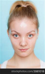 Young woman in facial peel off mask. Peeling. Beauty and skin care. Studio shot on blue background. Woman in facial peel off mask.